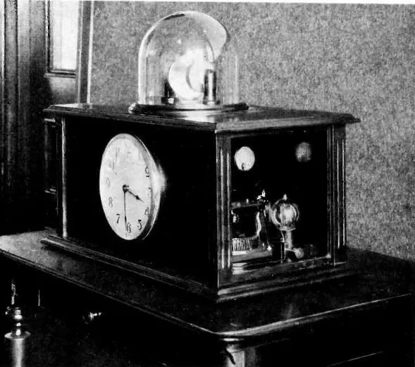 Warren Marrison's quartz crystal clock, 1927. The entire apparatus filled a room. Today the same idea fits in a watch case thinner than a pencil. Image: Electronics magazine (1931), public domain. Warren Marrison's original quartz clock at Bell Labs, 1927 — a room-sized apparatus of vacuum tubes, circuits, and a quartz crystal resonator